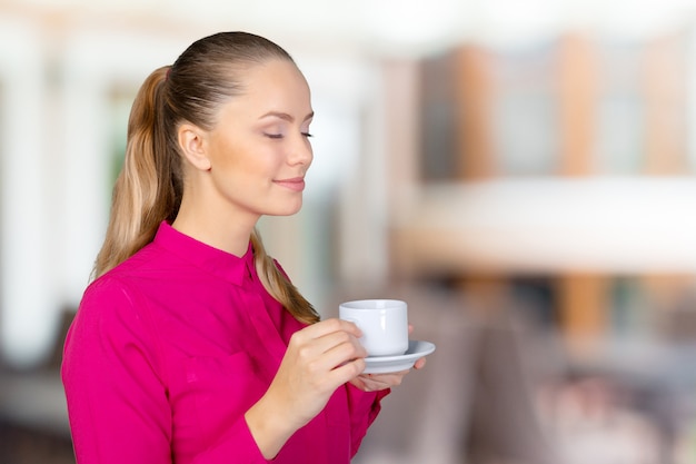 mulher sorridente com uma xícara de café