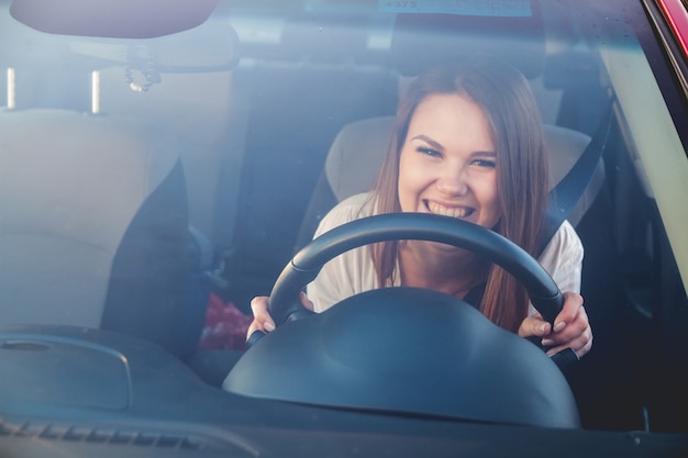 Mulher sorridente dirigindo carro