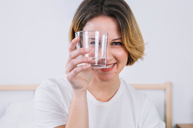 Foto mulher sorridente olhando a câmera através de vidro