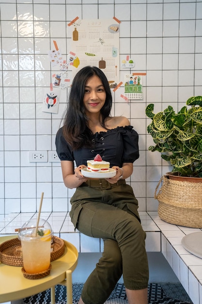 Foto mulher sorridente segurando sobremesa em casa