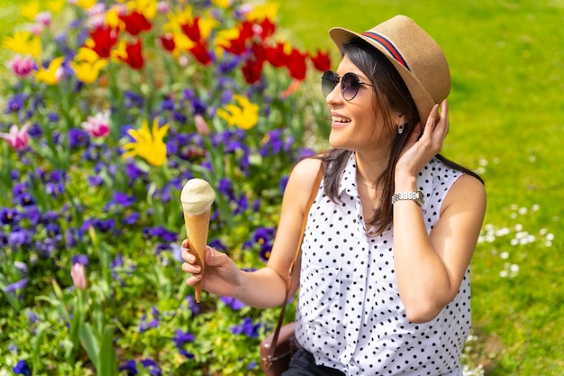 Mulher turista gostando de visitar a cidade comendo um sorvete de pistache aproveitando as férias de verão e tendo um conceito de viajante feminina solo de câmera