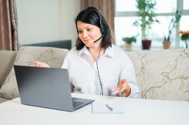 Mulher usando fone de ouvido sem fio estudo online assistir webinar briefing online educação à distância