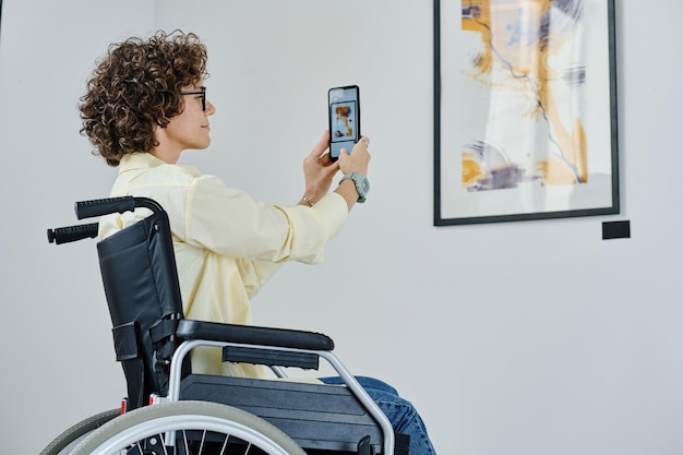 Mulher usando smartphone na galeria de arte