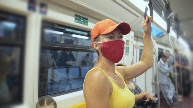 Mulher viaja passeio caucasiano no trem aéreo com máscara médica protetora Menina turista no trem aéreo com respirador Máscara de pessoas