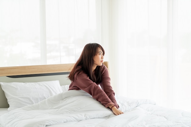 Mulheres asiáticas na cama e acordar de manhã