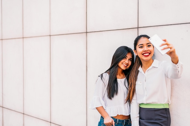 Mulheres asiáticas sorridentes tirando selfie