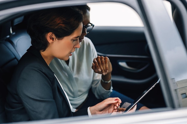 Mulheres de negócios a discutir enquanto estão sentadas no carro.