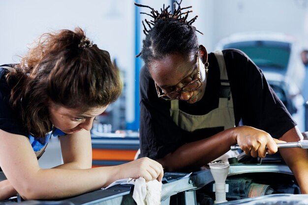 Mulheres em uma oficina de reparo trabalhando para consertar carros