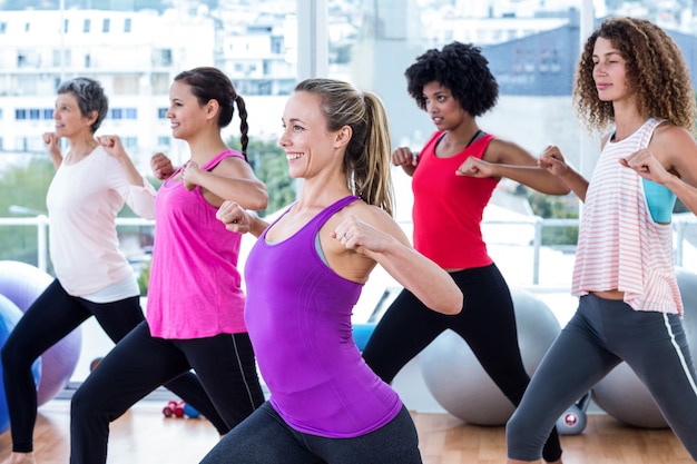 Mulheres, exercitando com as mãos entrelaçadas e alongamento