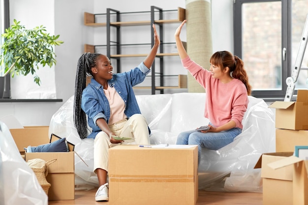 Mulheres felizes a mudar-se para uma nova casa e a contar dinheiro.