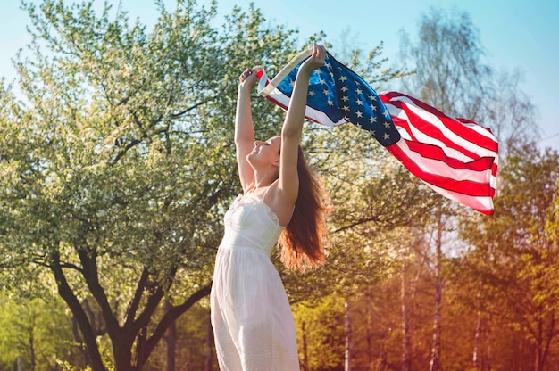 Mulheres felizes com a bandeira americana nos eua comemoram 4 de julho