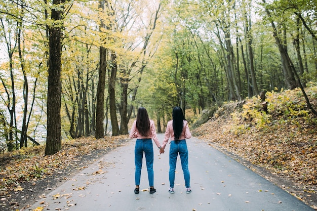 Mulheres irreconhecíveis de mãos dadas