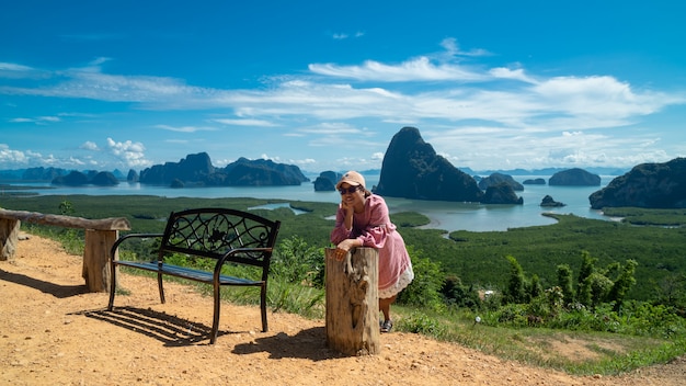 Mulheres jovens felizes, apreciando a vista do vale do topo de uma montanha