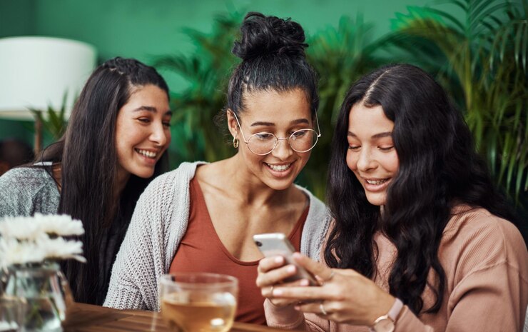 Foto mulheres telefonam e amigos no café juntos para app de chat de mídia social e reunião com ligação gen z pessoas móvel e irmãs e irmãs em café para blog on-line leitura de fofoca história e amor