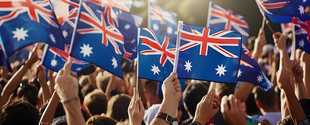 Multidão aplaudindo com bandeiras australianas no ar em um concerto