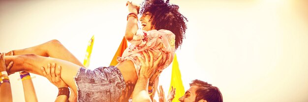 Multitud de mujer hipster feliz surfeando en un festival de música