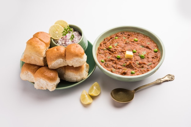 Mumbai Style Pav bhaji é um prato de fast food da Índia, que consiste em um curry de vegetais grosso servido com um pãozinho macio, servido em um prato