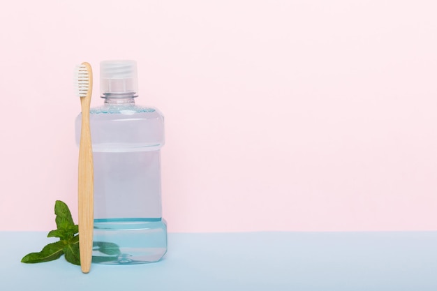 Mundwasser und frische Minze auf Draufsicht des farbigen Hintergrundes mit Kopienraum für Text