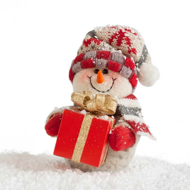 Muñeco de nieve de Navidad y año nuevo con caja de regalo roja y copos de nieve aislado sobre fondo blanco.