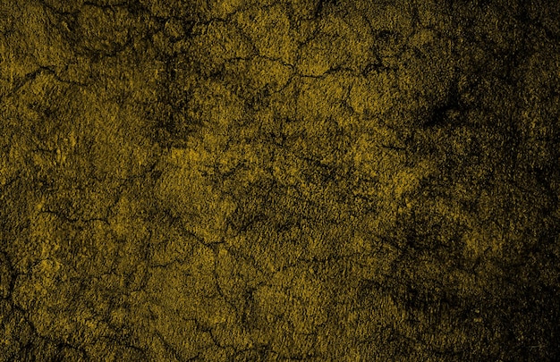 Muro de concreto amarelo escuro rachado com textura grunge abstrata
