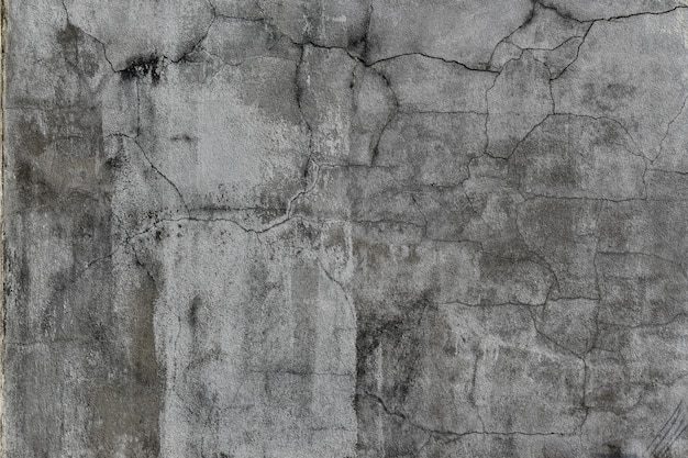Muro de concreto de grunge com rachaduras e manchas. Textura de cimento para design e plano de fundo.
