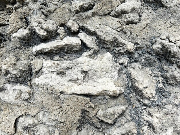 Muro de hormigón gris con grandes piedras Closeup Antecedentes