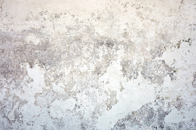 Muro de hormigón de textura blanca. Fondo de fundido pintado con grano de suelo sólido gris. Superficie rugosa y sucia.