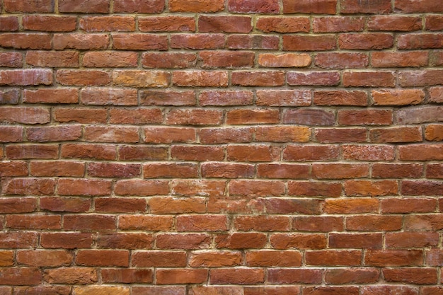 Muro de piedra de ladrillo de bloques rojos de fondo para el diseño