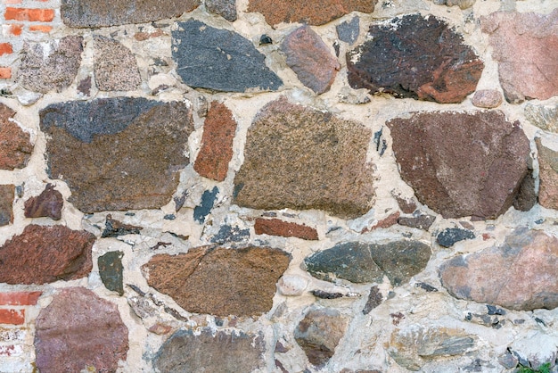Un muro de piedras irregulares Fondo de piedra de construcción vintage
