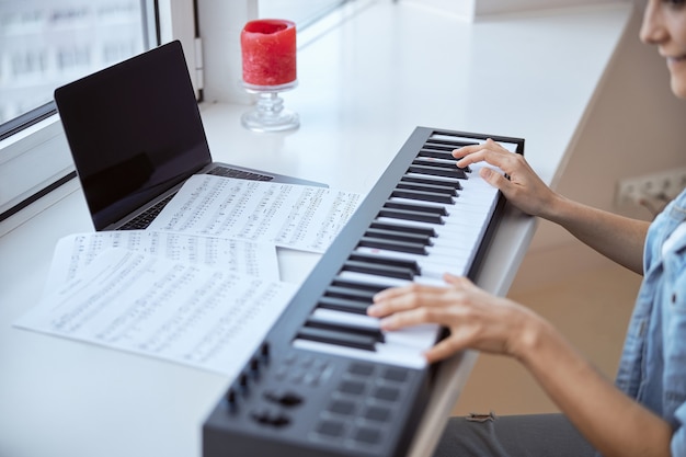 Foto músico alegre expressando positividade enquanto aprende uma nova melodia com as notas