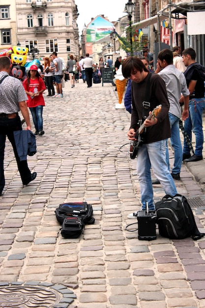 El músico toca la guitarra en la calle central de Lvov