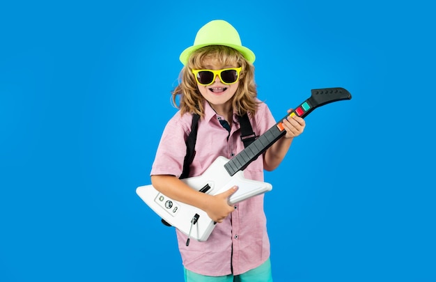 Musikausbildung Porträt des netten Kinderjungen an der Gitarrenpraxis Lustiges Felsenkind mit Gitarre