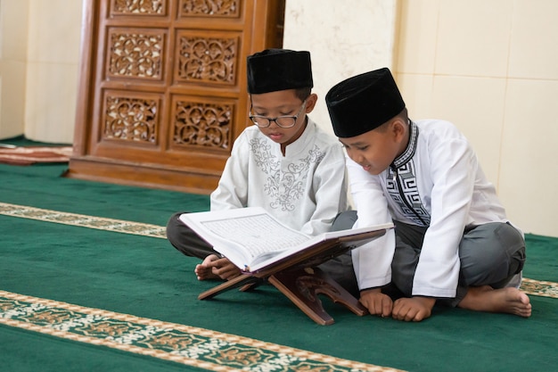 Muslimisches Kind, das Koran liest