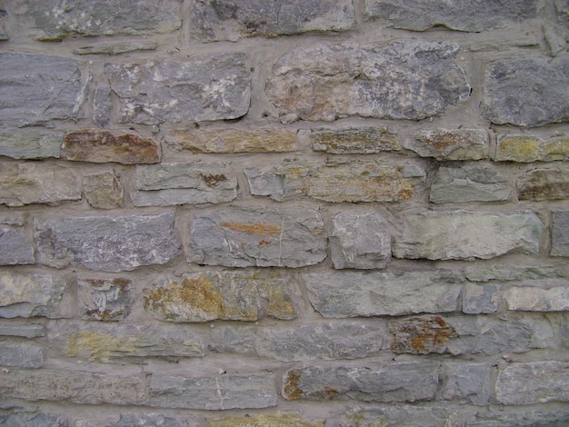 Mustergraue Farbe des modernen Stils. Antike Natursteinmauer. Steinwandoberfläche mit Zement. Steine oder Blöcke.