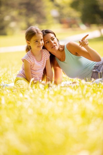 Mutter mit kleiner Tochter amüsiert sich an einem sonnigen Tag im Park