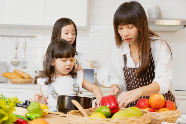 Mutter und Kind freuen sich, gesundes Essen in der heimischen Küche aus Gemüse und Obst zuzubereiten