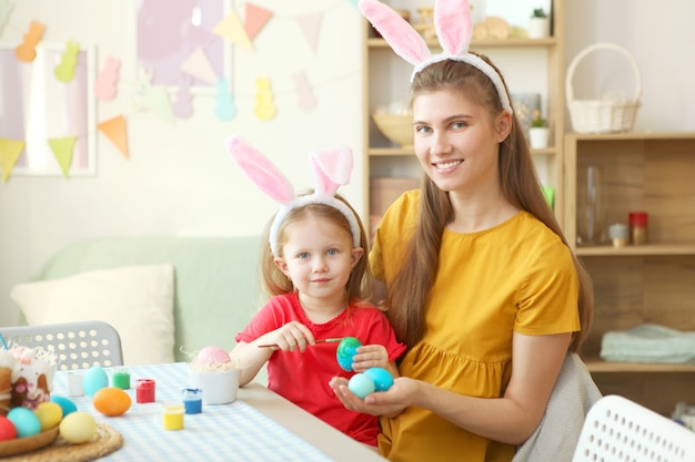 Mutter und Tochter bemalen Ostereier für die Ostertraditionen