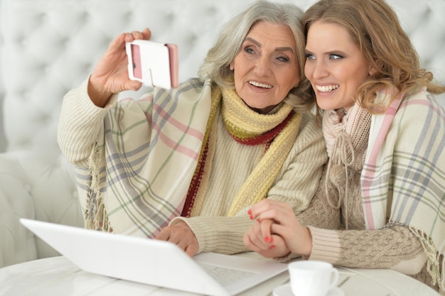 Mutter und Tochter verbringen Zeit zusammen und benutzen Laptop