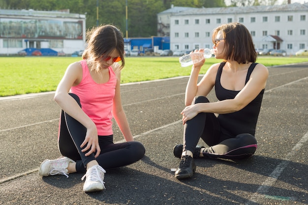 Mutter- und Tochterjugendlicher, der am Stadion stillsteht