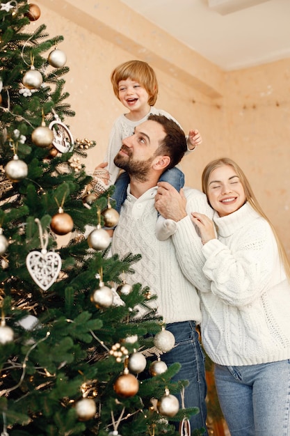 Muttervater und ihr Sohn schmücken den Weihnachtsbaum zu Hause