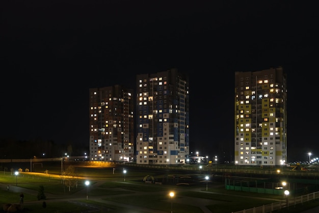 Nachtpanorama von Licht in den Fenstern eines mehrstöckigen Gebäudelebens in einer Großstadt