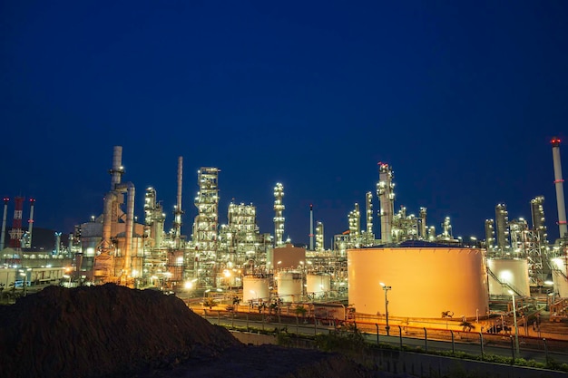 Nachtszene der Ölraffinerieanlage und Lagerung von weißem Tanköl der petrochemischen Industrie in der Dämmerung