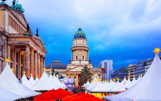 Nachtweihnachtsmarkt am Gendarmenmarkt im Winter Berlin, Deutschland. Deutsche Straßenweihnachts- und Weihnachtsmesse. Adventsdekoration und Stände mit Kunsthandwerk auf dem Basar.