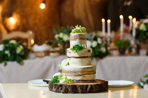 Nackte Hochzeitstorte dekoriert mit frischem Blumengrün köstliches Dessert beim Hochzeitsbankett