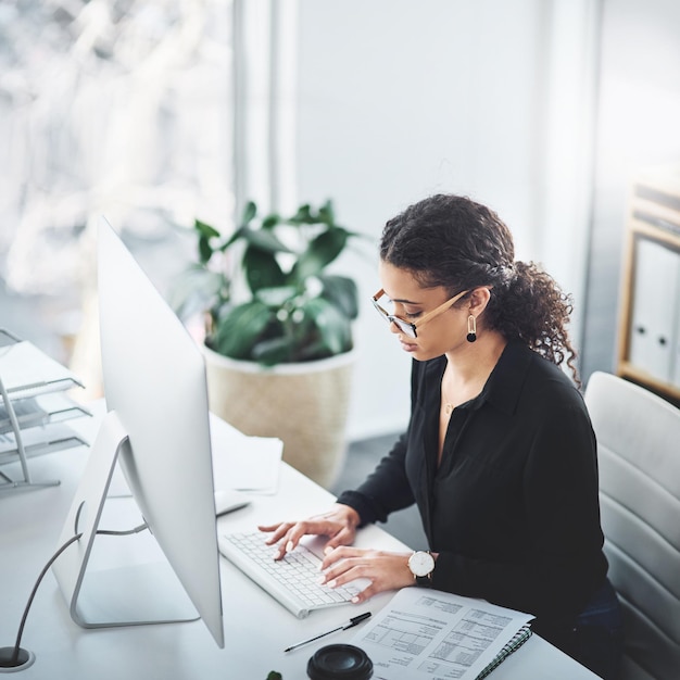 Foto nada destrozará una mente enfocada como la suya fotografía de una joven mujer de negocios que trabaja en una computadora en una oficina