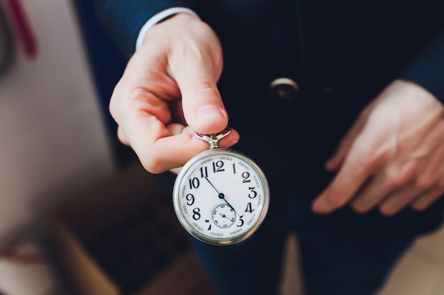 Nahaufnahme der Hände mit Vintage Taschenuhr retro.