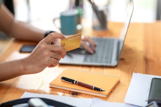 Nahaufnahme der Hand des Mannes mit Kreditkarte Online-Shopping-Konzept.