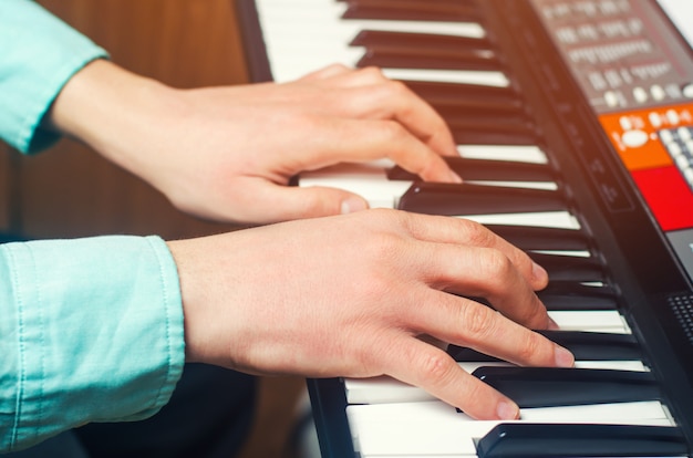 Foto nahaufnahme der hand eines musikkünstlers, die das klavier, die hand des mannes, klassische musik spielt