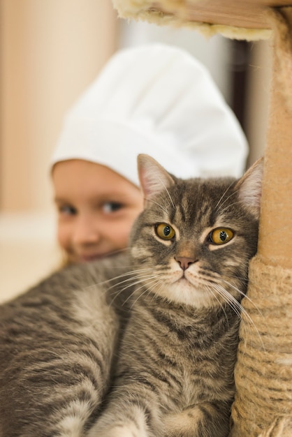 Nahaufnahme der Katze vor lächelndem kleinem Mädchen