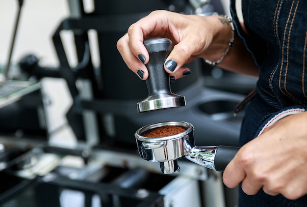 Nahaufnahme der weiblichen Hände. Barista kocht Kaffee.